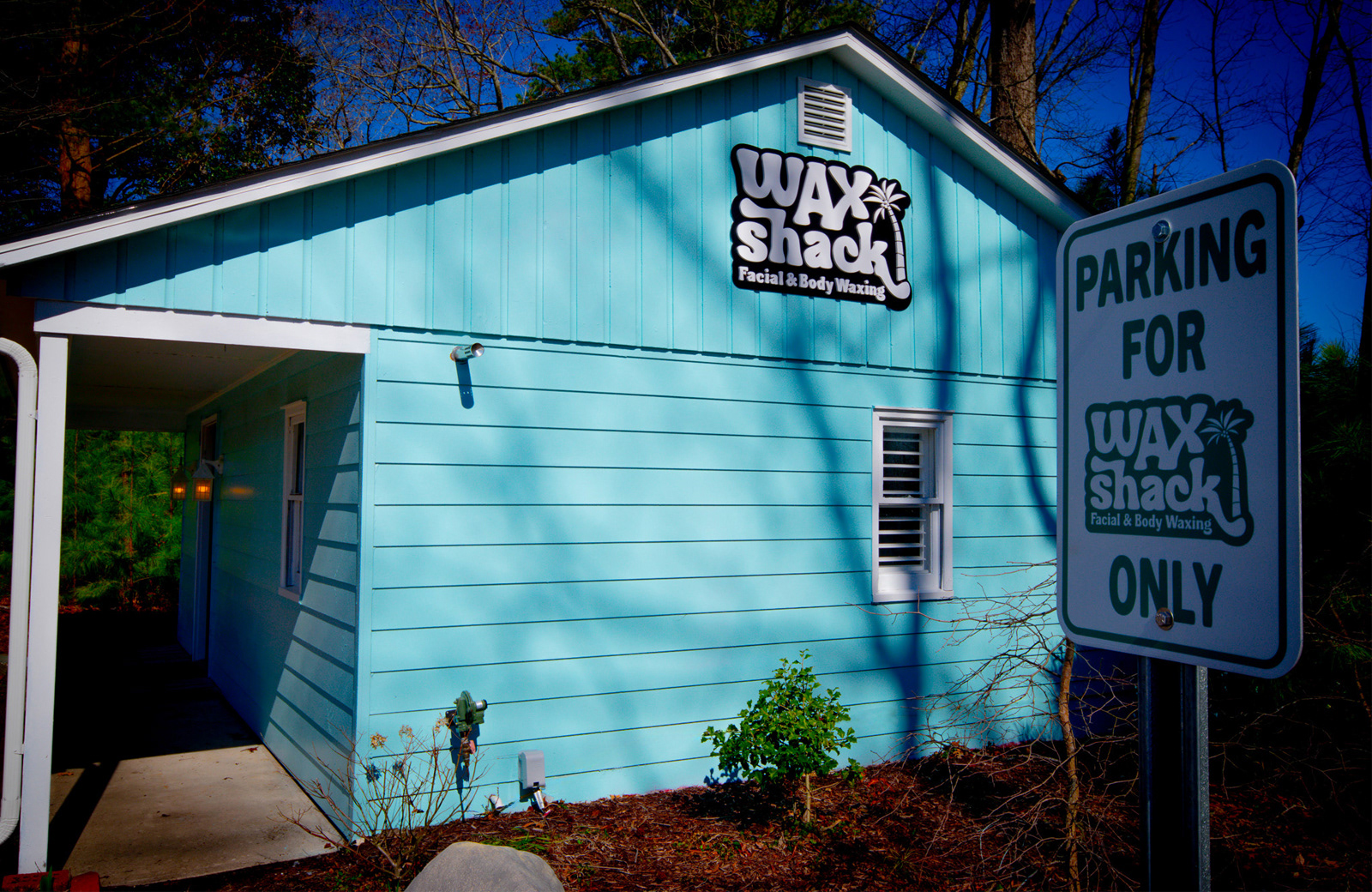Exterior photo of Wax Shack showing the signage and custom parking sign Exterior photo of Wax Shack showing the signage and custom parking sign