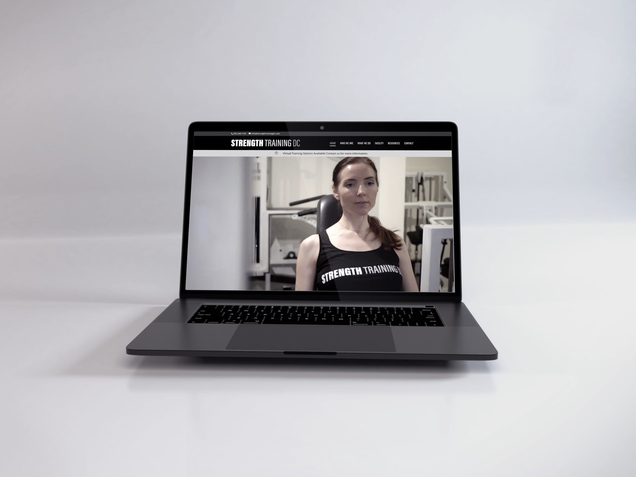 Laptop showing the Strength Training DC website