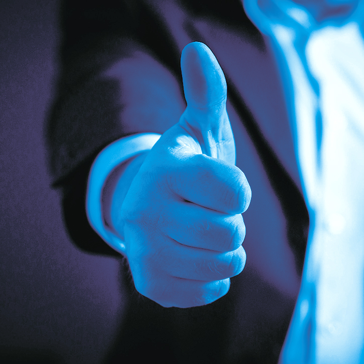 man in a suit showing a thumbs up man in a suit showing a thumbs up